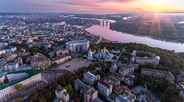 The sun rising in the background of a Ukrainian city