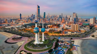 Skyline view of Kuwait City, Kuwait at dusk.