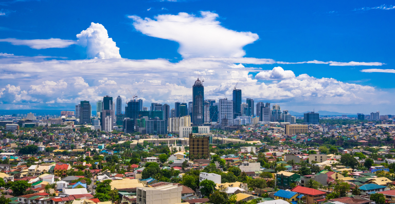 Manila city by Day showing Ortigas and suburban buildings in the foreground With the Bonafacio Global city centered in the background.