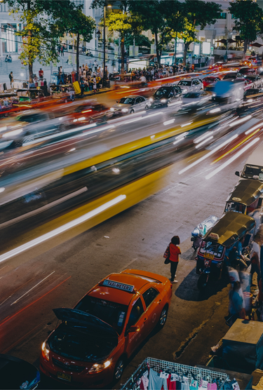 An image of a busy city street in Asia at night