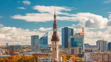 Aerial cityscape with old town hall spire and modern office buildings skyscrapers in the background in Tallinn in the day, Estonia