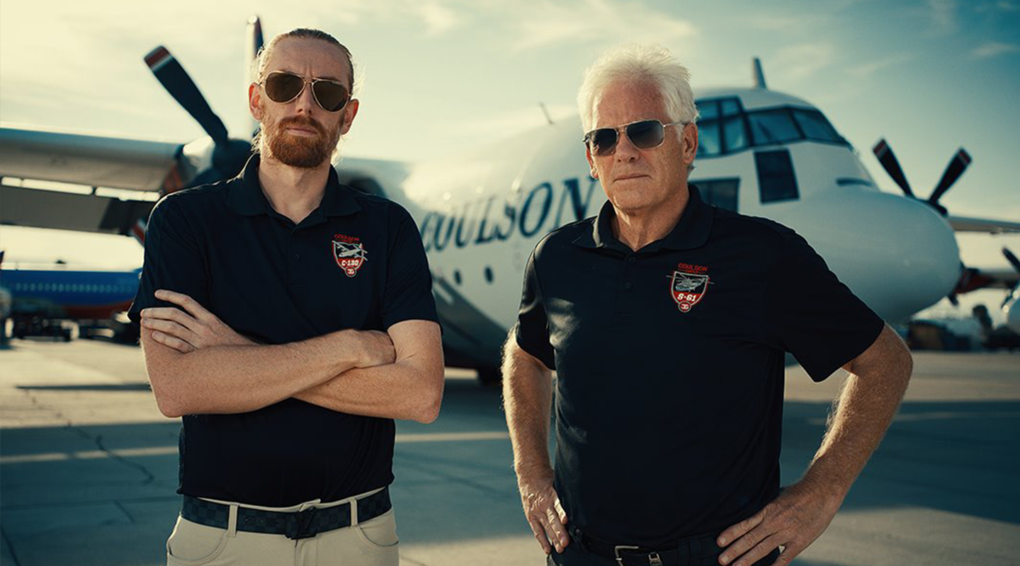 Coulson Aviation founders standing in front of plane wearing sunglasses.