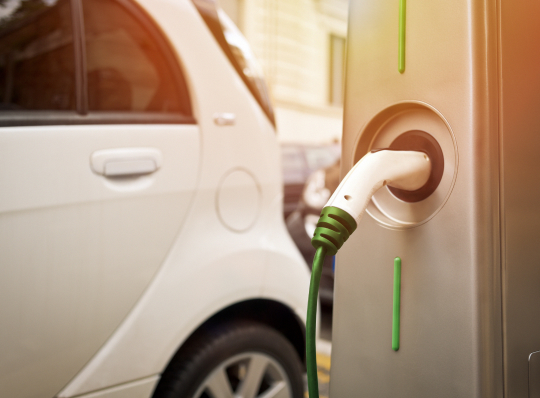  An electric car charging on the street