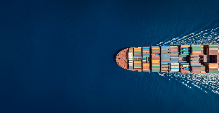 Aerial view of a container ship in blue ocean, representing global trade