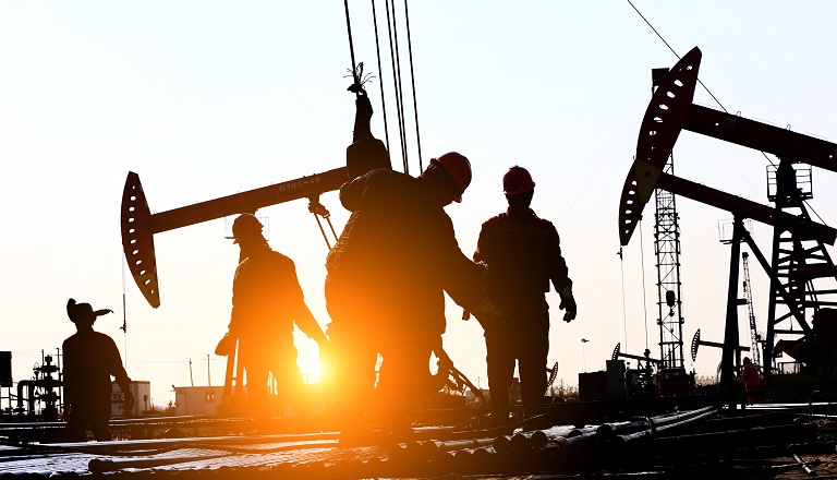 Oil workers work on oil-patch rig