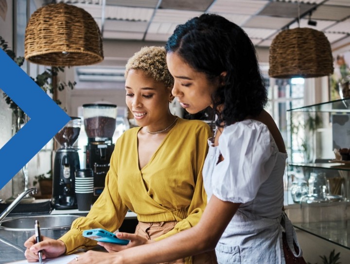 Two servers have a conversation in a coffee shop