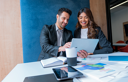 Two business colleagues looking at a tablet