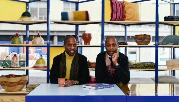 Twin brothers and cofounders of Goodee, Byron & Dexter Peart sit confidently behind a desk