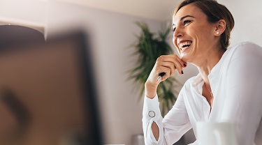 Smiling business woman on her laptop 