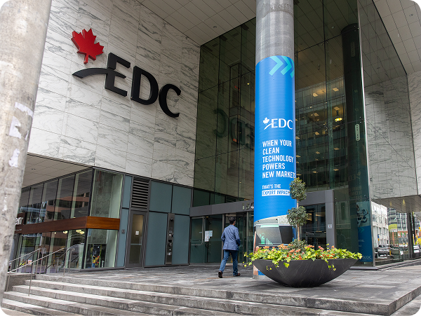 EDC head office entrance in Ottawa with logo and blue sign on pillar.