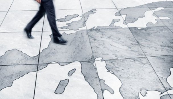Un homme marchant sur une carte de l’Europe.