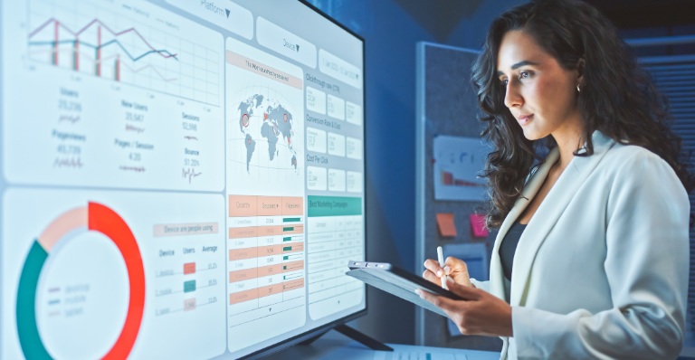 Woman reviews digital trade data from online platforms