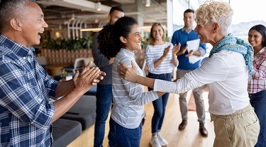 Canadian, Colombian businesspeople shake hands at meeting