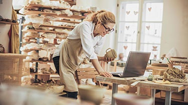 A person in a workshop looking at a computer.