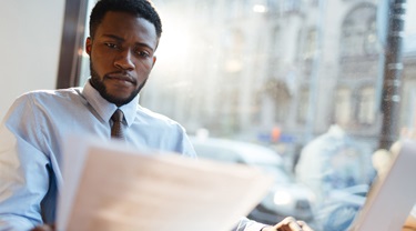 A young professional reviewing an international contract