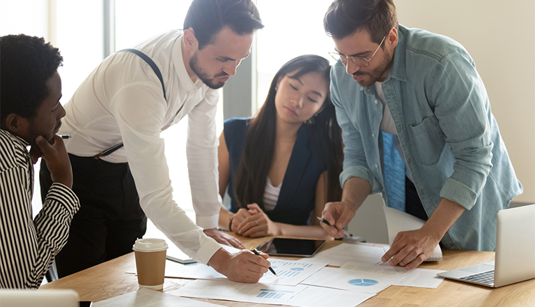 group of people working together at a table