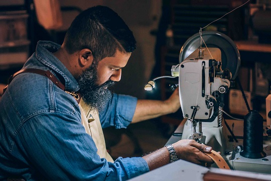 Man running machinery, sewing or embroidery machine