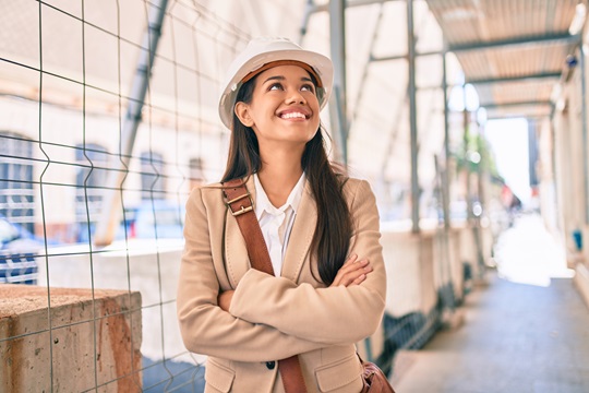 Smiling female architect walks through building