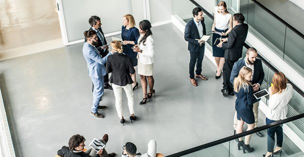 Arial view of a group of business and government officials standing and talking at an event