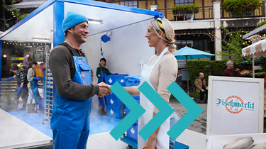 Two people shake hands at a fish market, representing Canadian exporters expanding trade beyond the U.S.