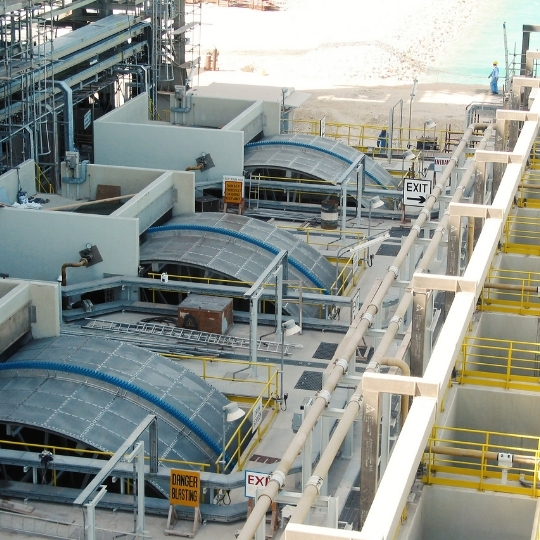 Équipement industriel de traitement de l'eau doté de systèmes de tamisage circulaires et de passerelles d'accès.