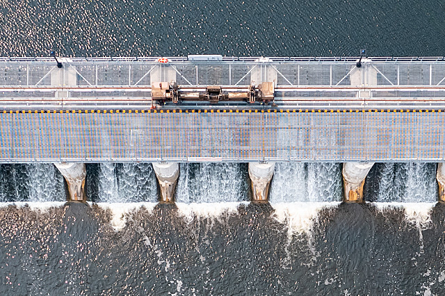 Aerial view of water rushing through a hydroelectric dam