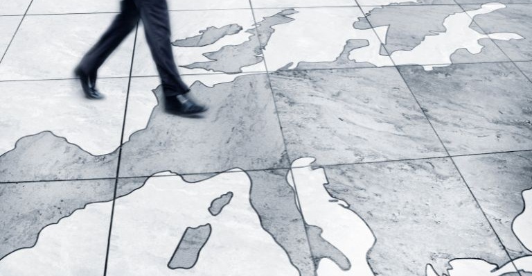 Man walking on floor map of Europe.