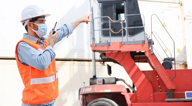 Engineer directs forklift in stockyard