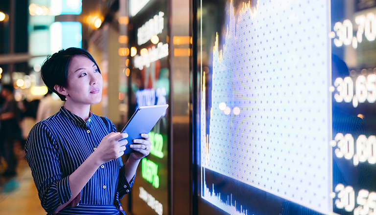 Person viewing financial graph on computer that suggests fluctuating currencies.