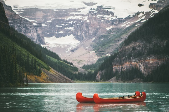 Two red canoes on a lake