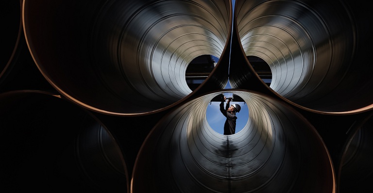 Engineer checks large industrial pipes