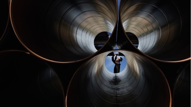 Engineer checks large industrial pipes