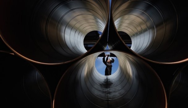 Engineer checks large industrial pipes