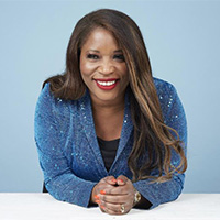 Claudette McGowan, CEO of Protexxa, seated at a table.