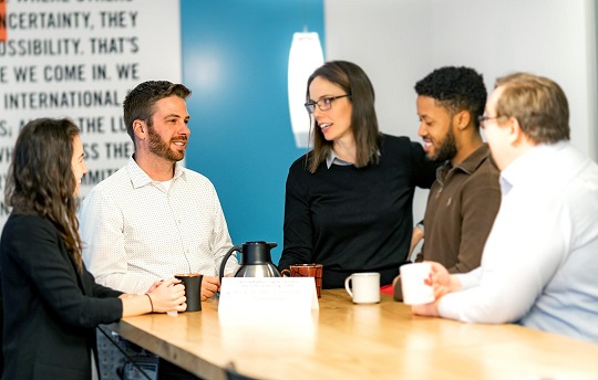 EDC employees discuss learning and development over coffee