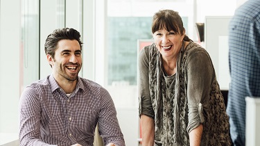 Smiling EDC employees in a meeting