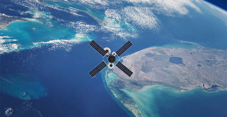 Satellite orbiting Earth over ocean and coastline. 