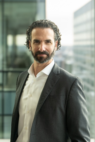 Head shot of Stuart Bergman, EDC’s chief economist, standing by glass window.